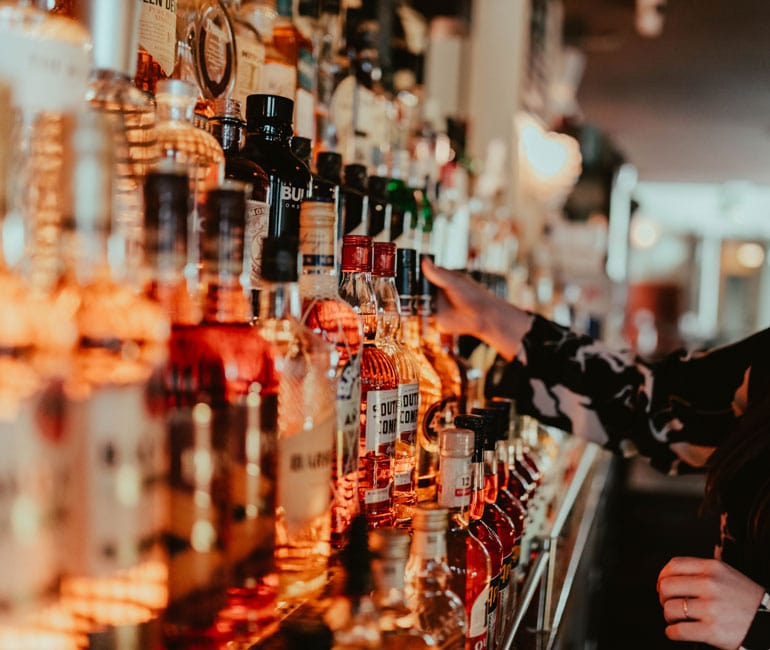 Illustration of a bar in which there are many different bottles